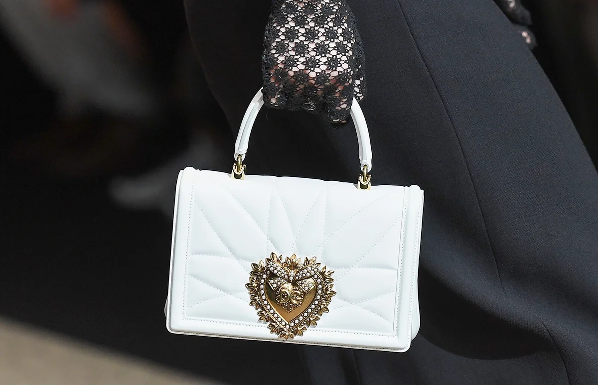 A model, bag detail, walks the runway at the Dolce & Gabbana show during Milan Fashion Week Fall/Winter 2018/19 on February 25, 2018 in Milan, Italy | Getty Editorial Use