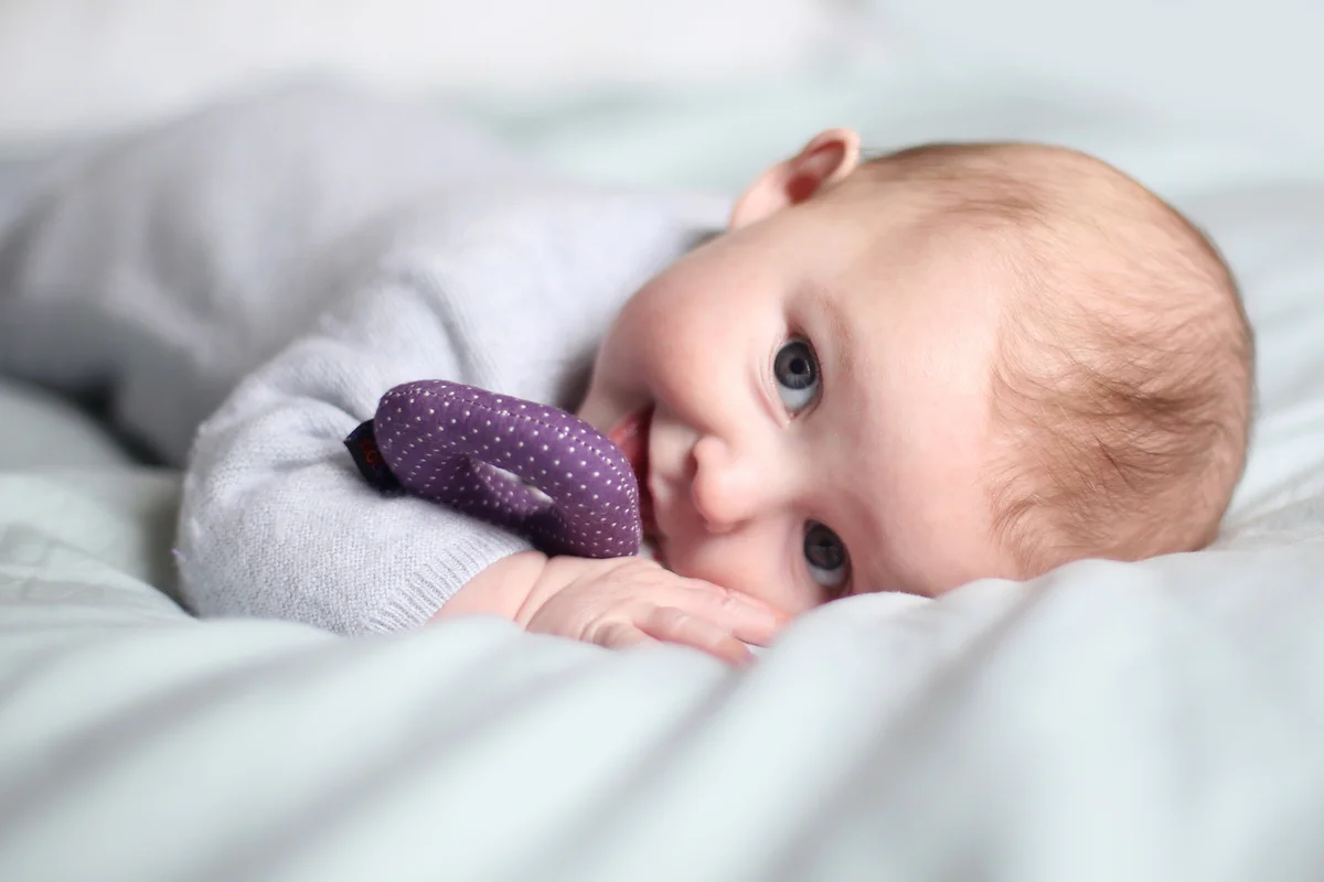 A 5 month old baby girl smiling