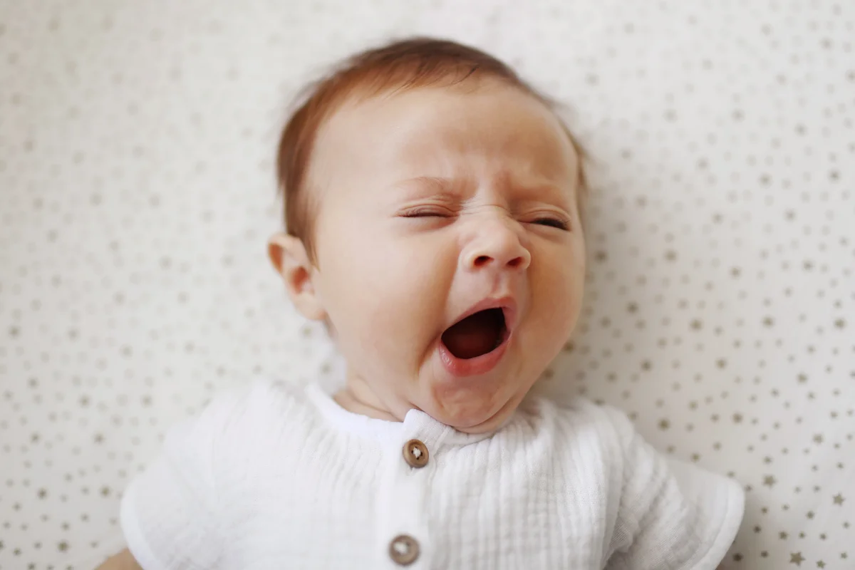 A 4 month old baby girl yawning