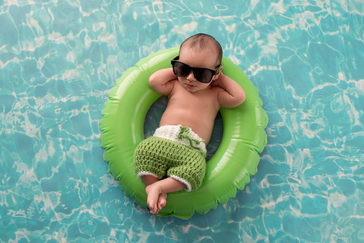 Newborn Baby Boy Floating on a Swim Ring