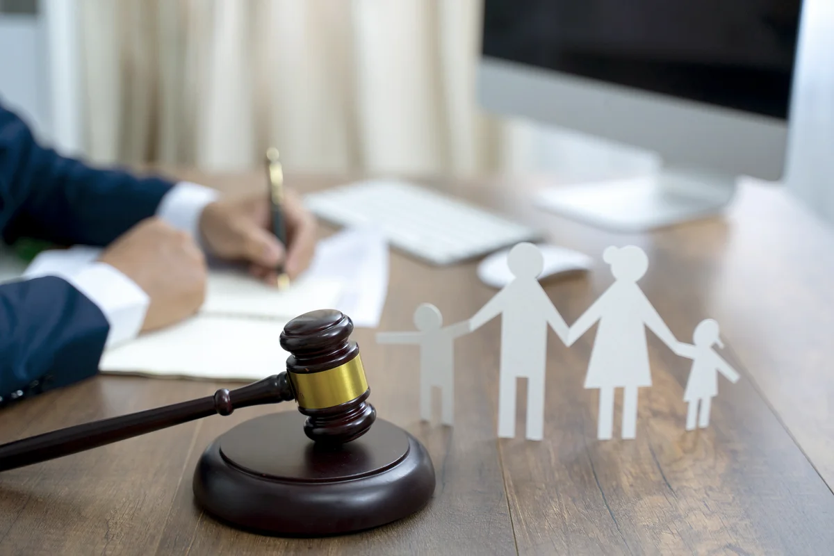 Family figure and gavel on wooden table