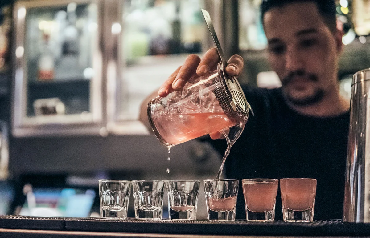Young adult man serving at the bar