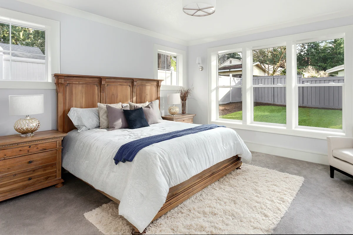 Bed between two windows