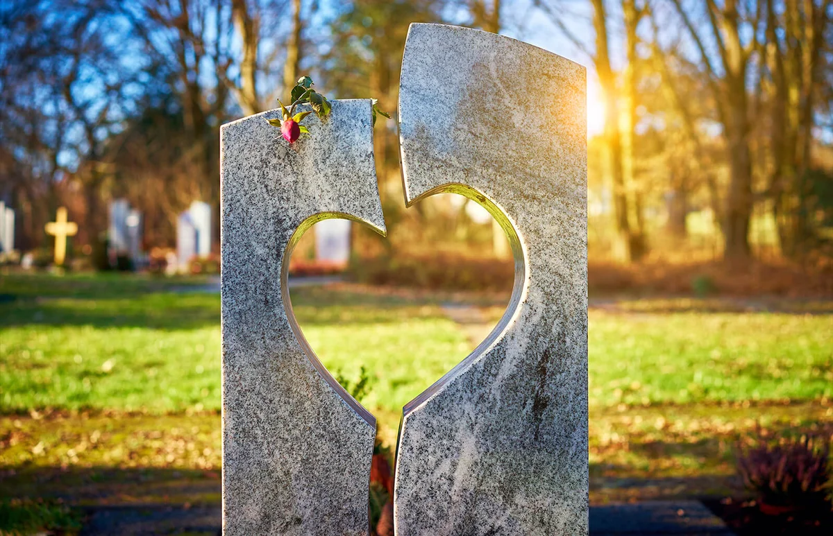 Gravestone with heart withered rose
