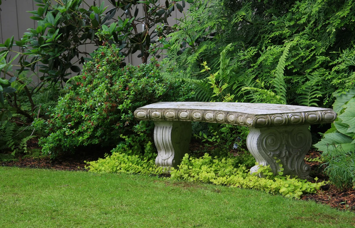 Intricate granite bench in a beautiful garden setting