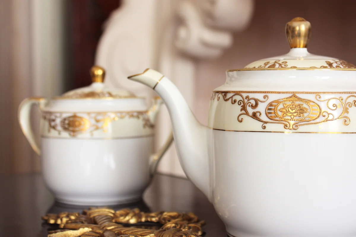White and gold porcelain teapot and sugar bowl