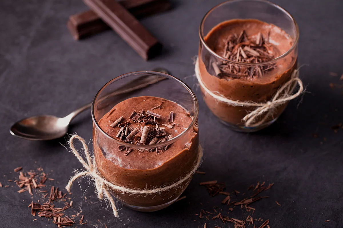 Homemade dark chocolate mousse on black surface