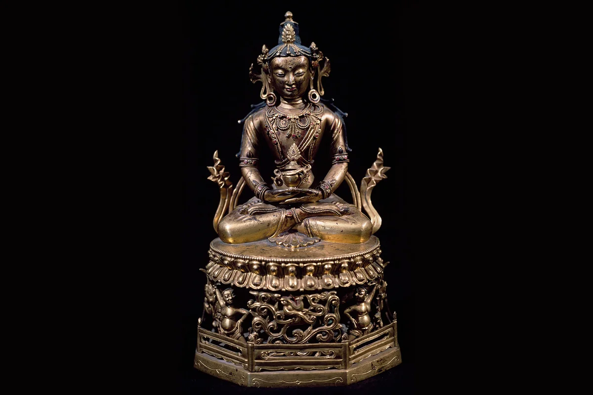 Amitayus, Buddha of Long Life, sitting in meditation holding the vase of long life in his hand, bronze statue, Tibet | Getty Editorial Use