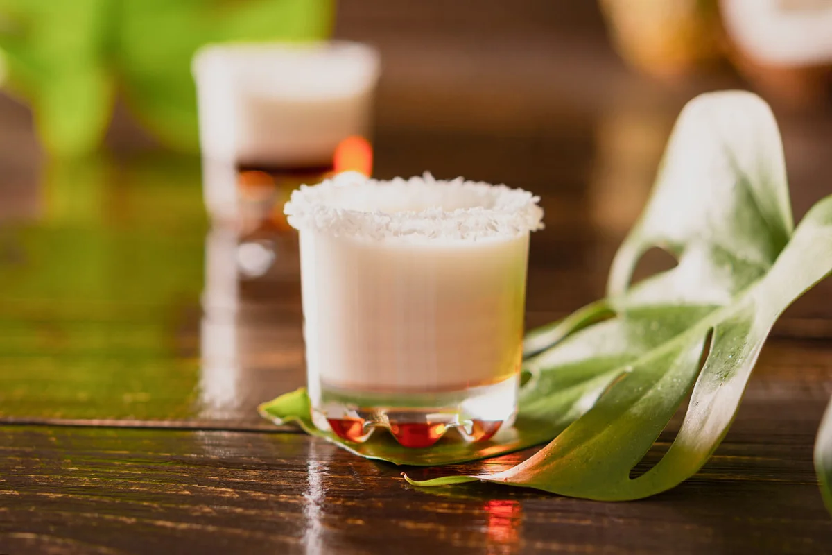 Tropical alcoholic shots decorated with coconut flakes
