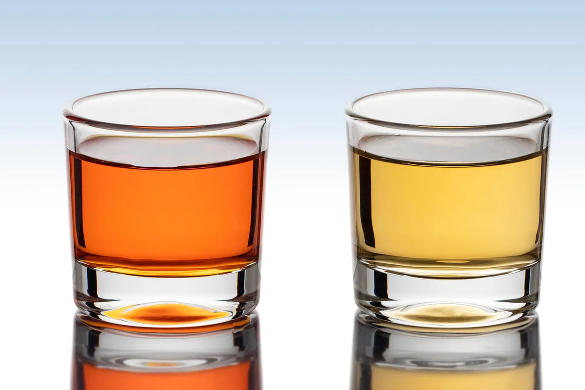 Shot glass filled with liquor isolated on white