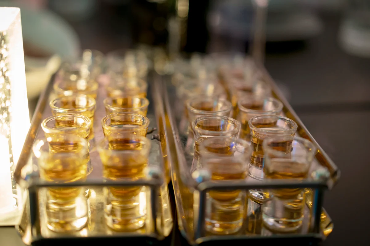 Shot glasses full of champagne