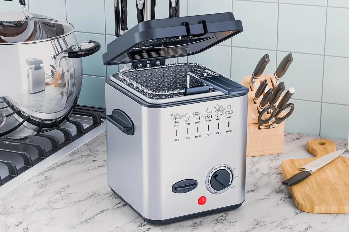 Domestic deep fryer on the kitchen table