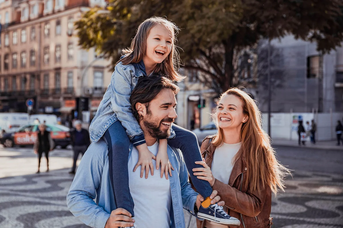 young happy family having a walk in the city