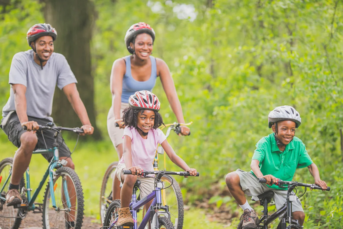 family is going on a bike ride through the woods while on summer vacation