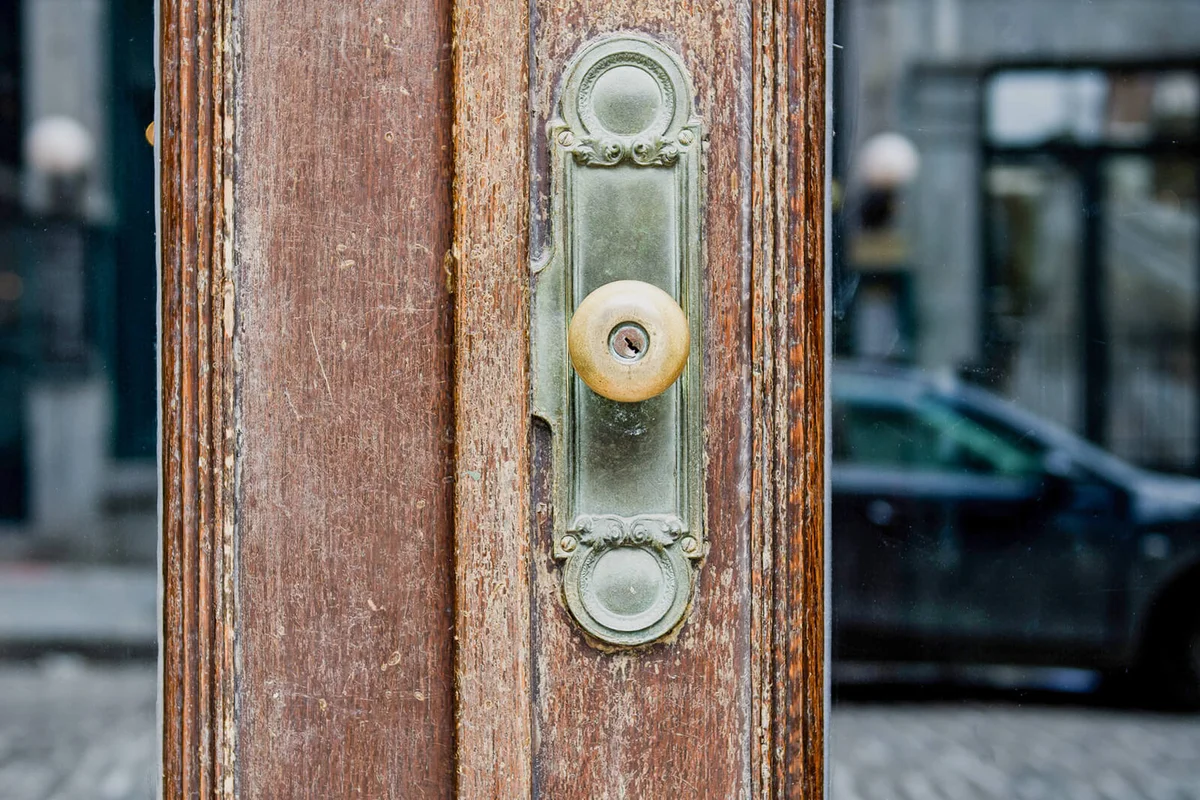 Old glass door with antique brass door handle