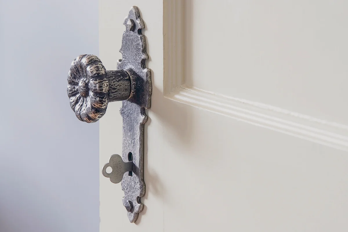 Open door with traditional doorknow and key