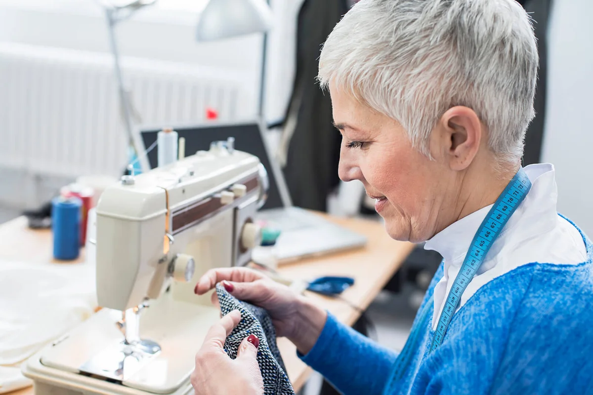 Seamstress sewing in her fashion studio