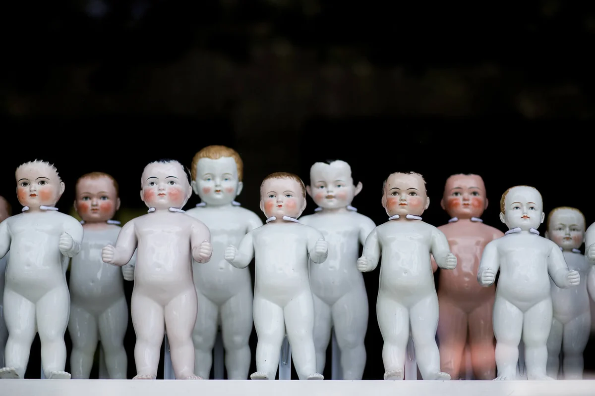 Porcelain bathing dolls in a row