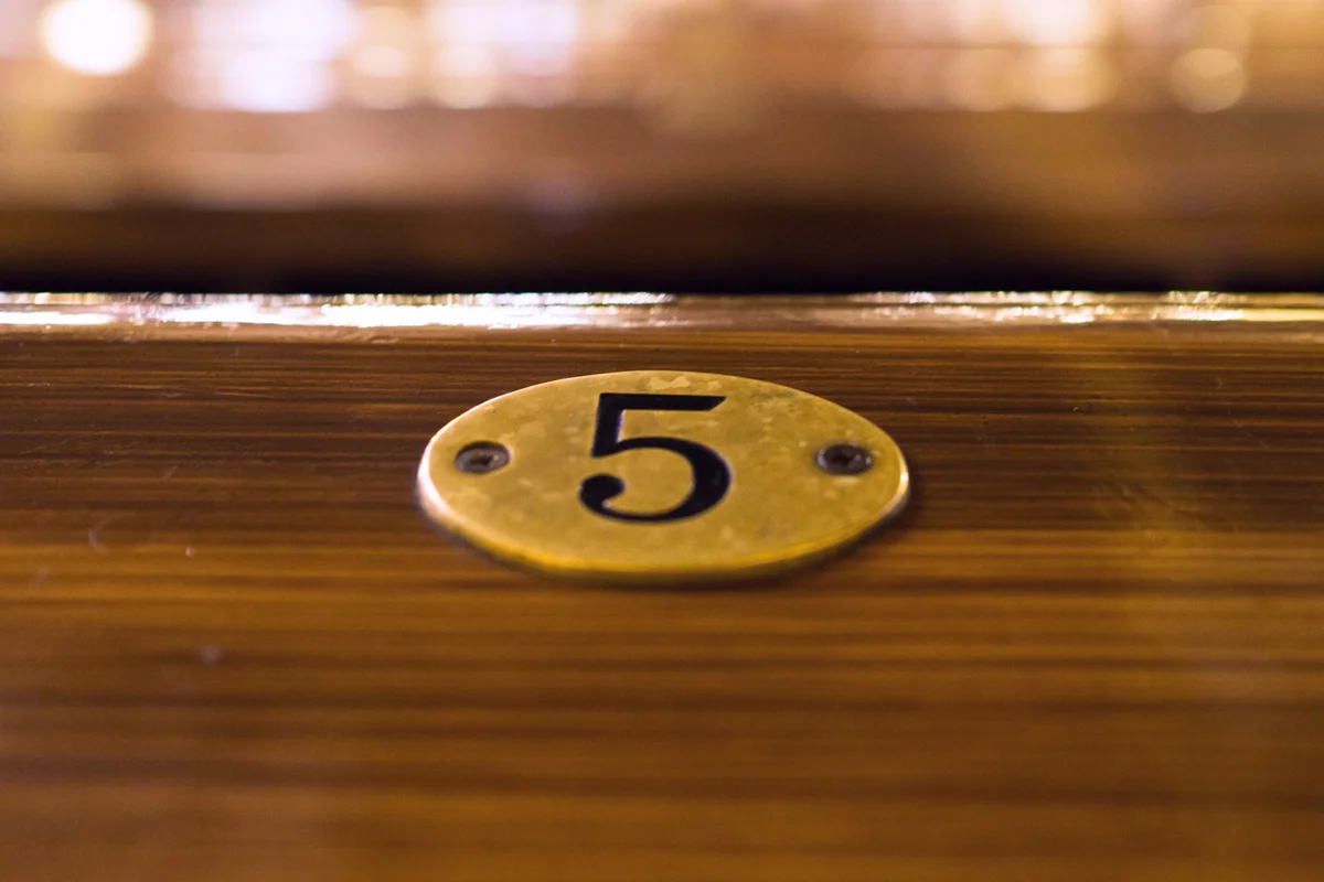 Close-Up Of Number 5 On Table