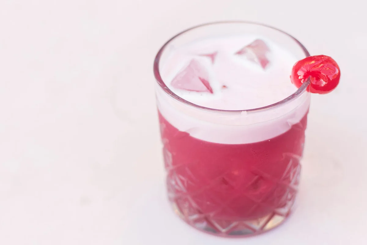 Pink cocktail with cherry