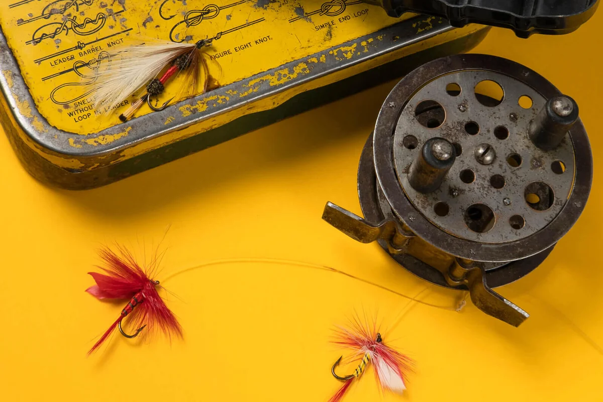 Vintage fishing tackle on yellow background