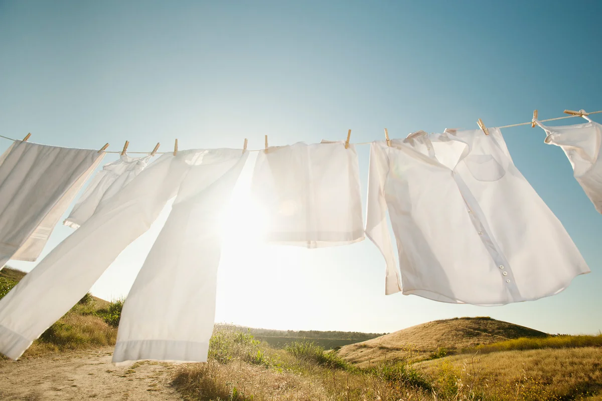 Laundry hanging on clothesline against blue sky