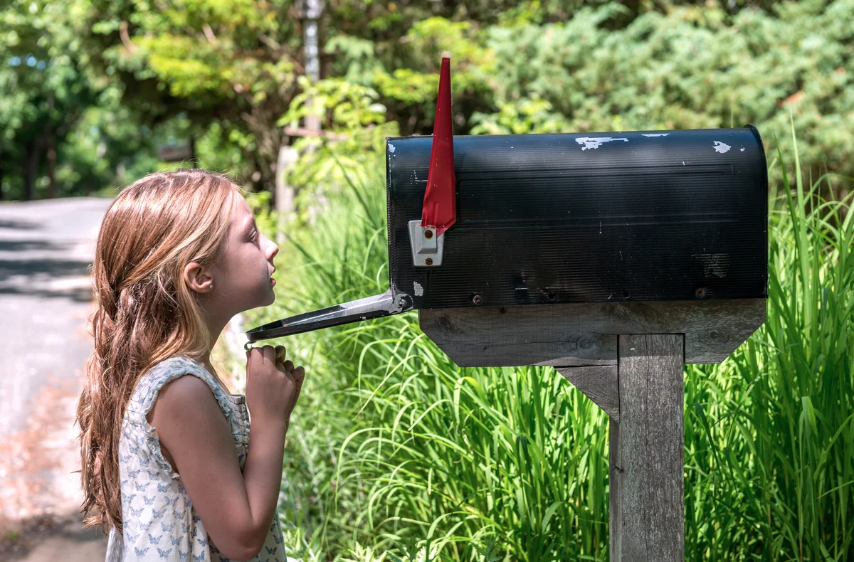 Girl Looking inside a mailbox
