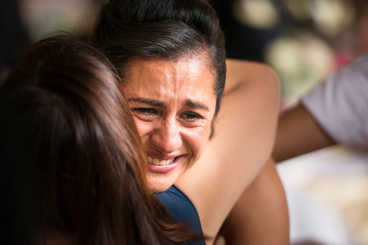 women hugging daughter and crying