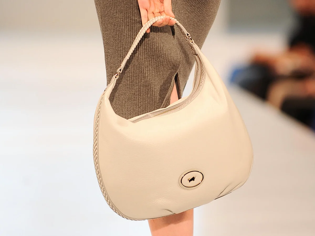 A model shows details of handbag collection as she walks the runway at Braun Buffel show | Getty Editorial Use