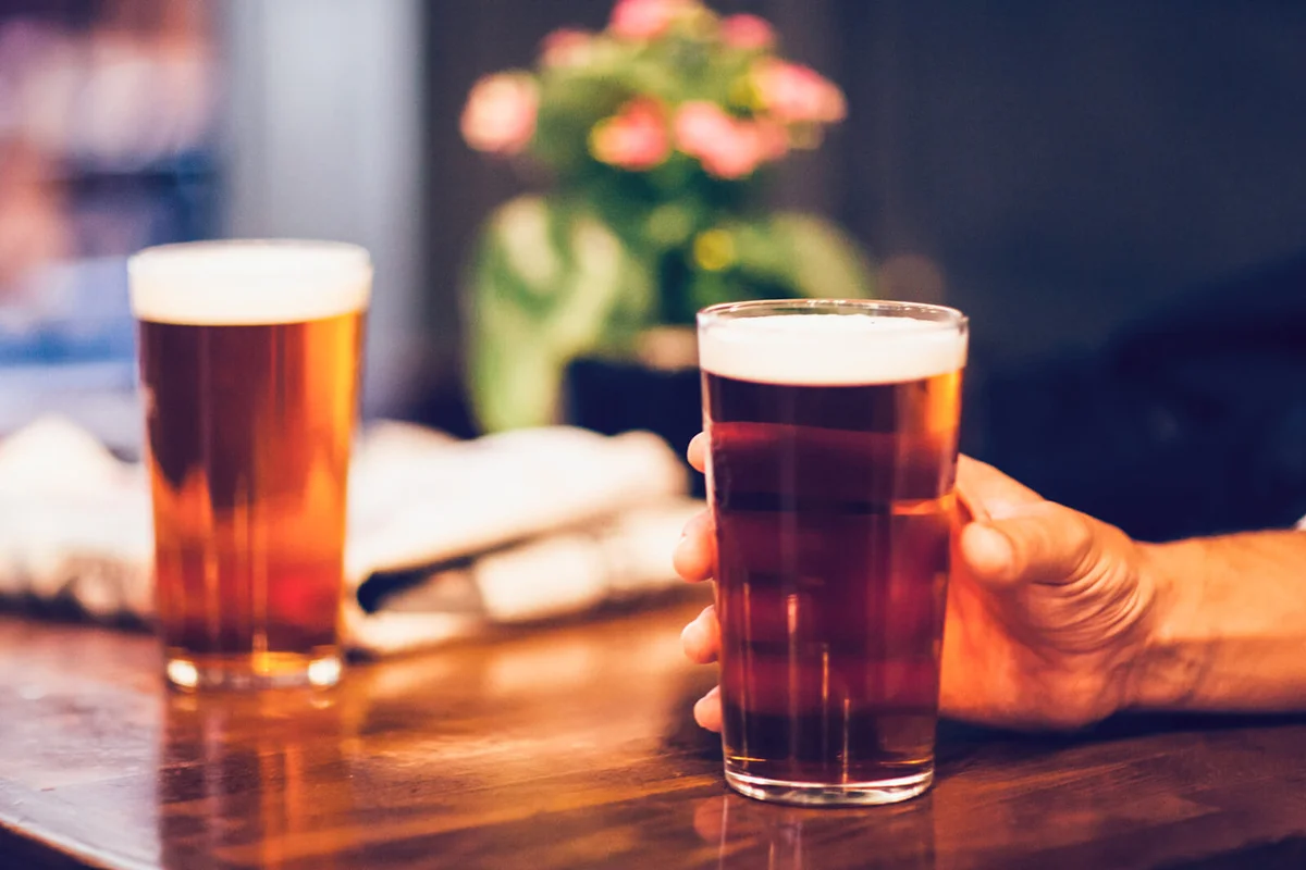 Two pints of beer on wooden table