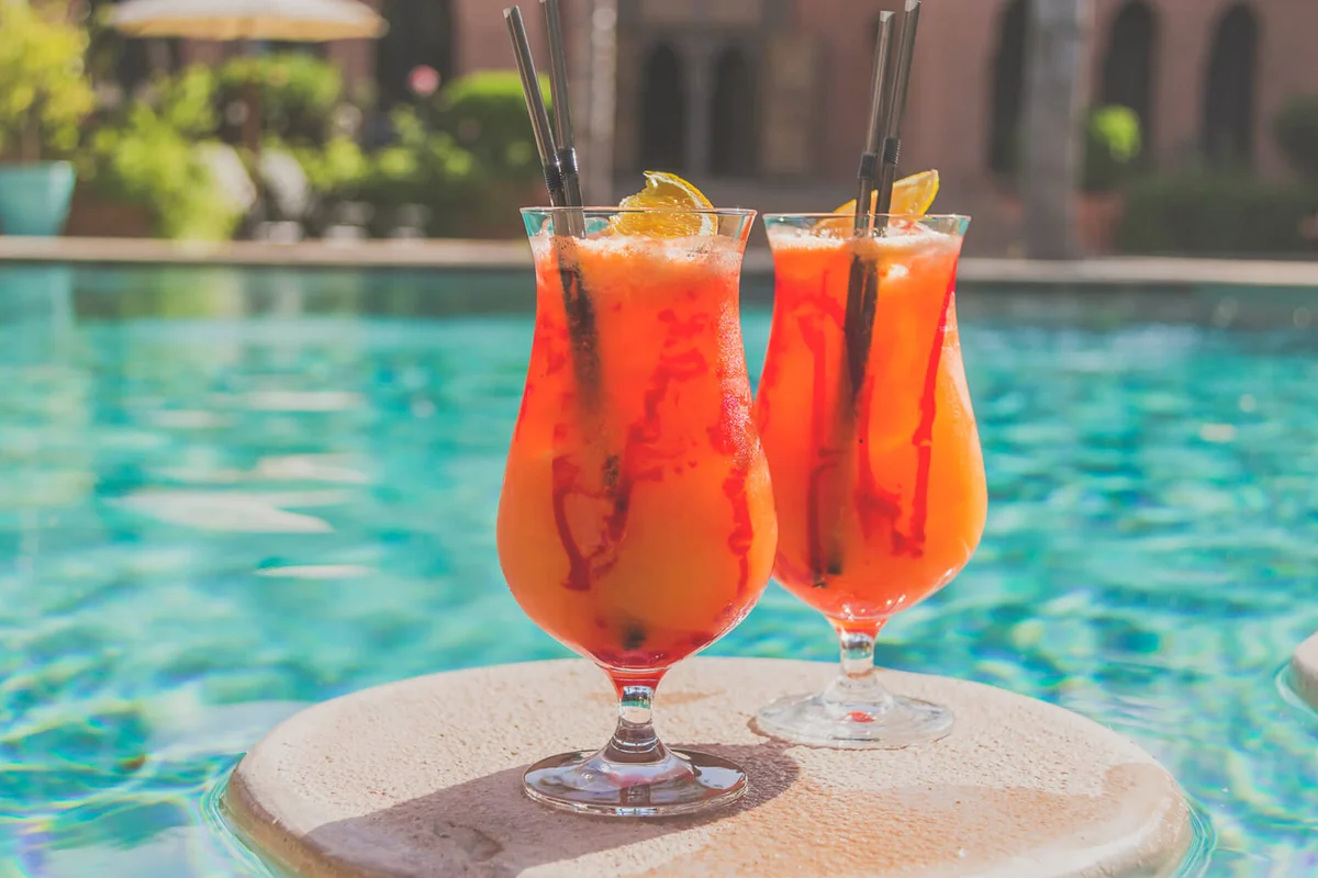 Fruity cocktails floating on swimming pool