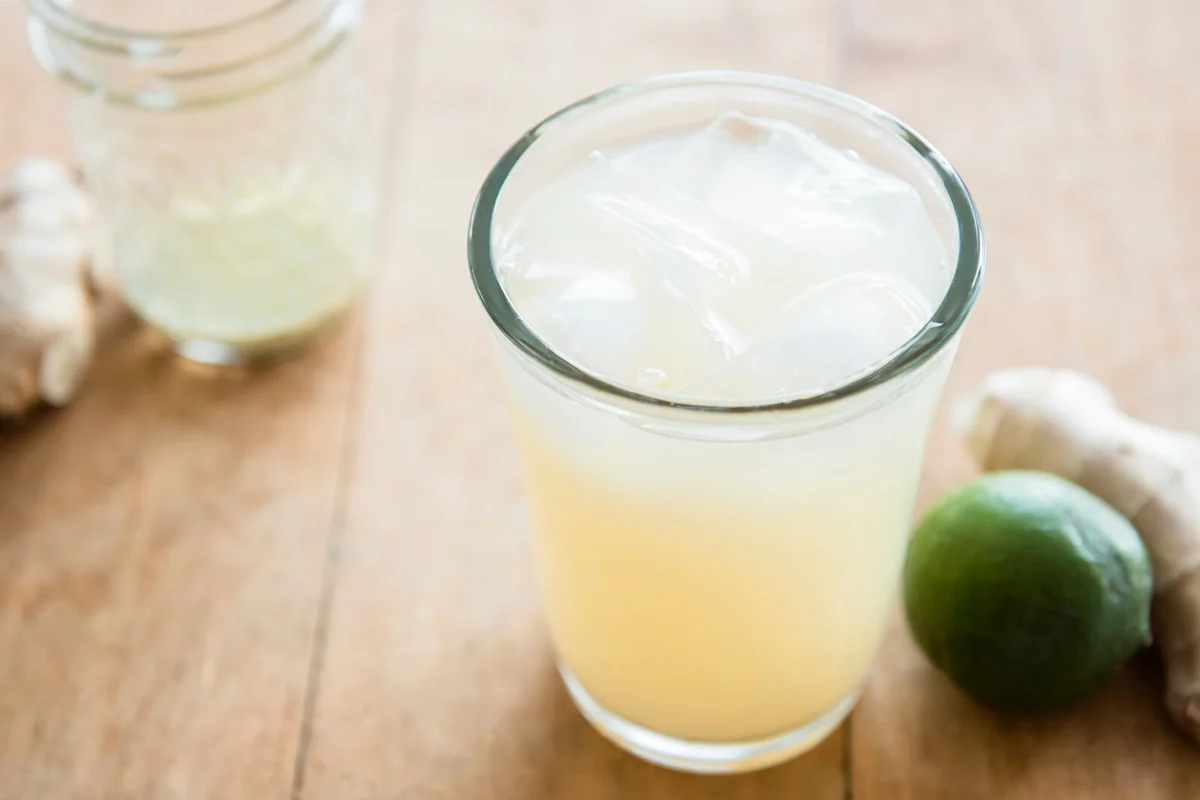 Ginger ale with ice cubes in drinking glass