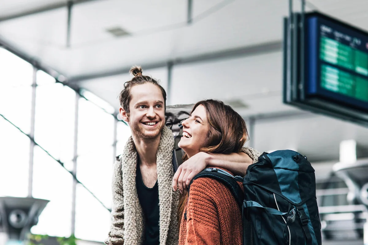 Young Backpacker Couple At The Airport