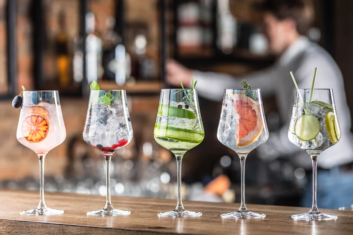 Selection of various cocktails in wine glasses in a bar