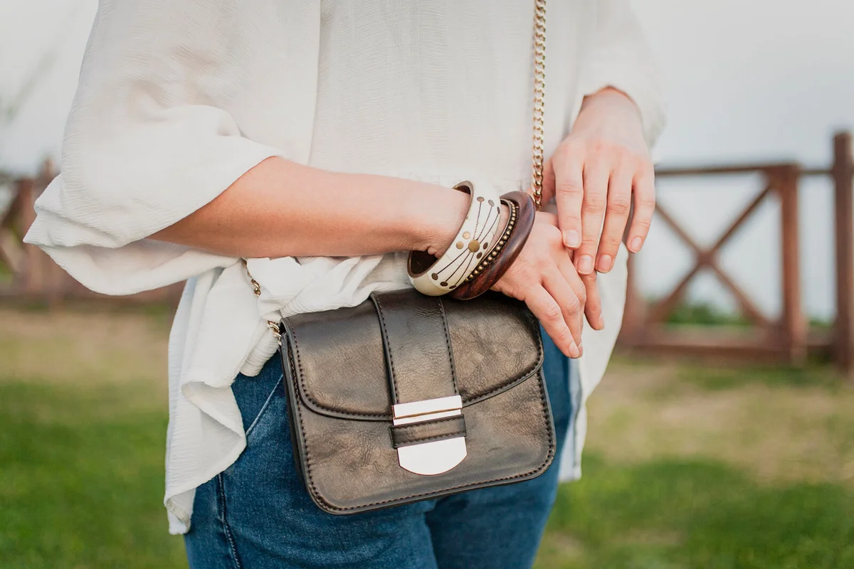 Trendy girl with black bag and wristband