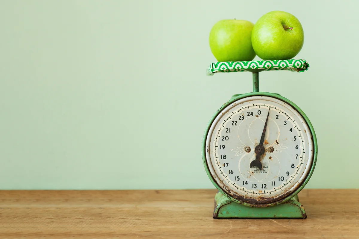 Apples on old-fashioned kitchen scale
