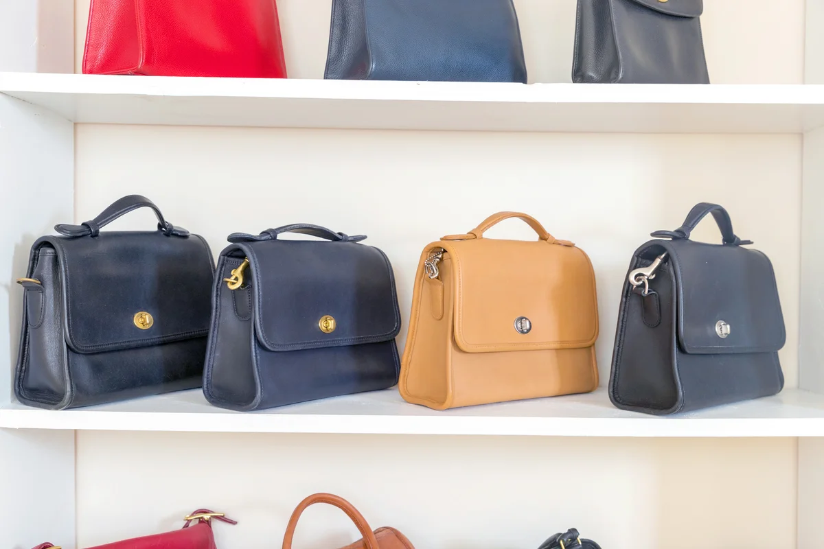 Handbags on a white shelf