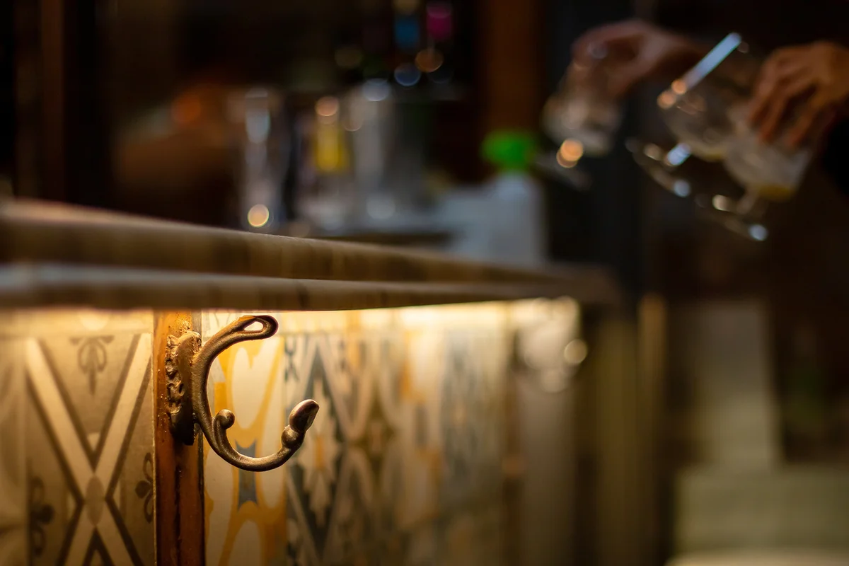 Purse hook on a bar