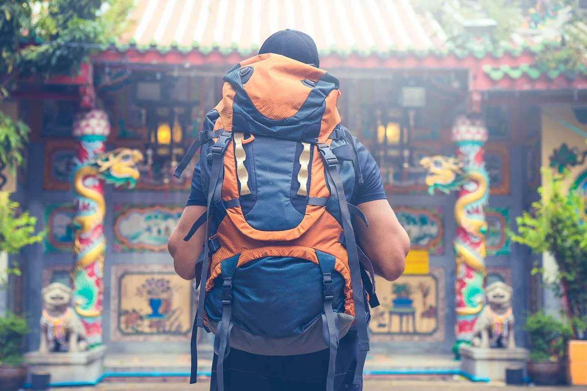 tourist backpacker visiting a temple in southeast asia