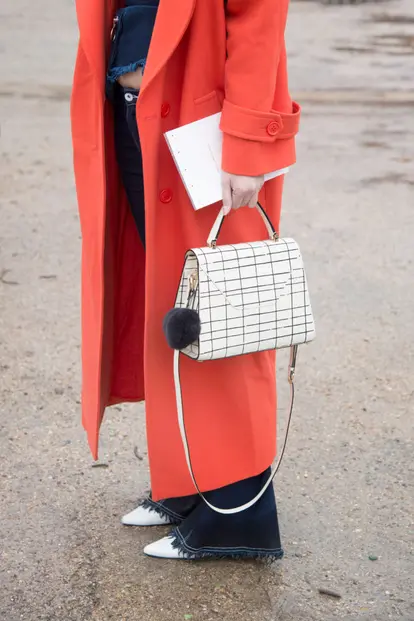 Stila Chan wears red jacket and a Valextra bag