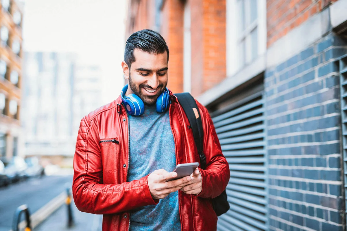 Handsome man in urban part of the city using phone