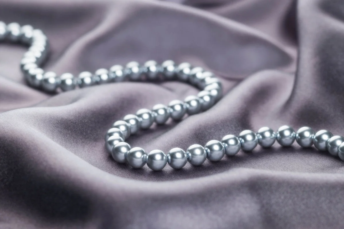 Necklace of pearls on gray satin