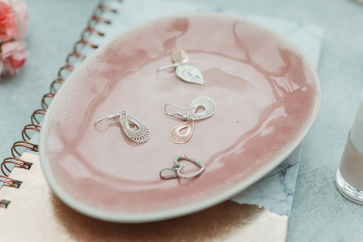 earrings jewelry on pink ceramic tray