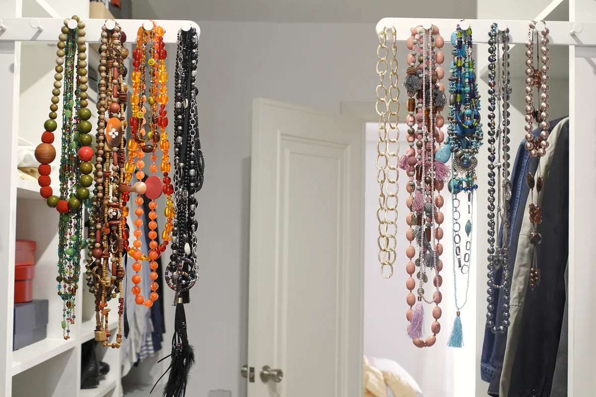 Necklaces hanging on rack in closet