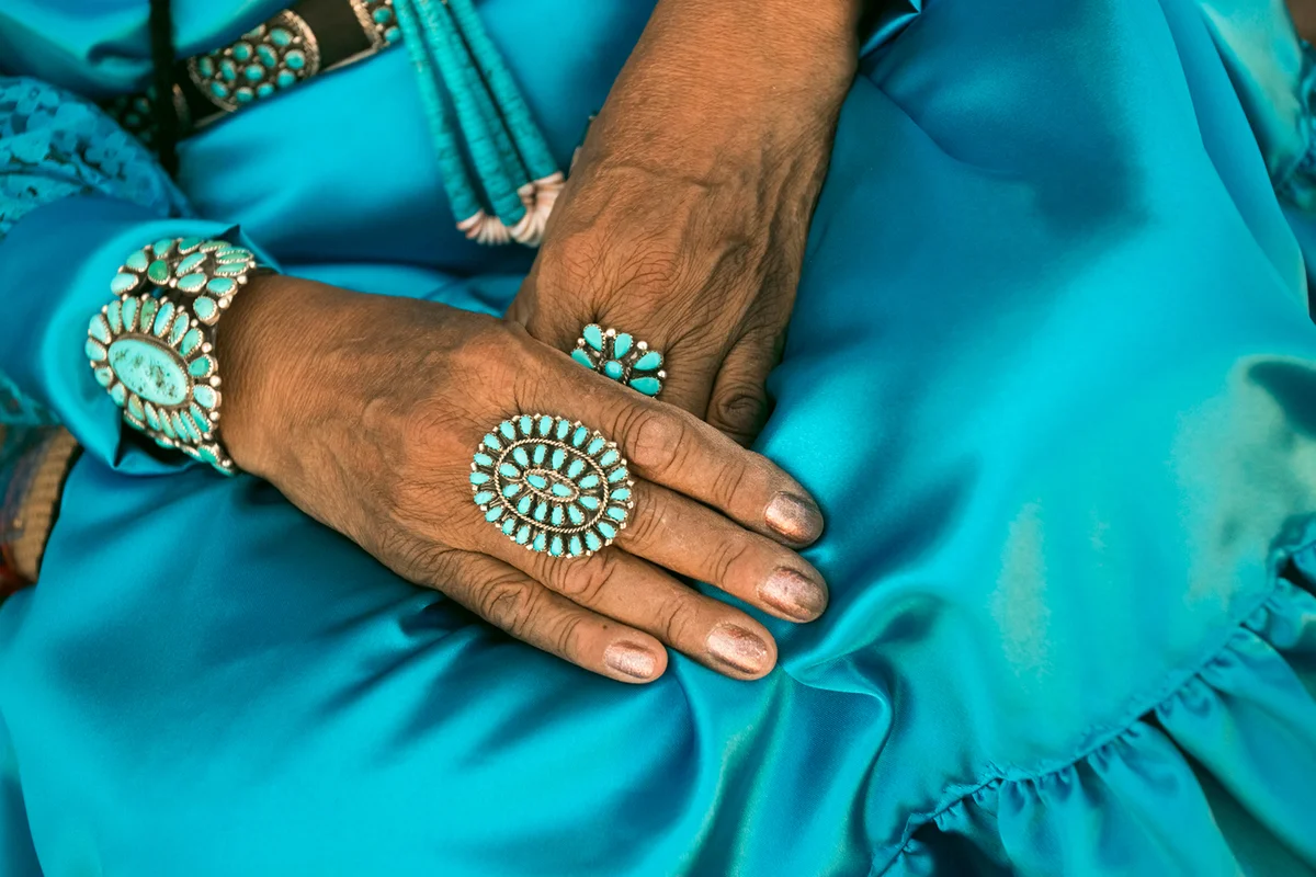 woman wearing traditional blue dress and rings