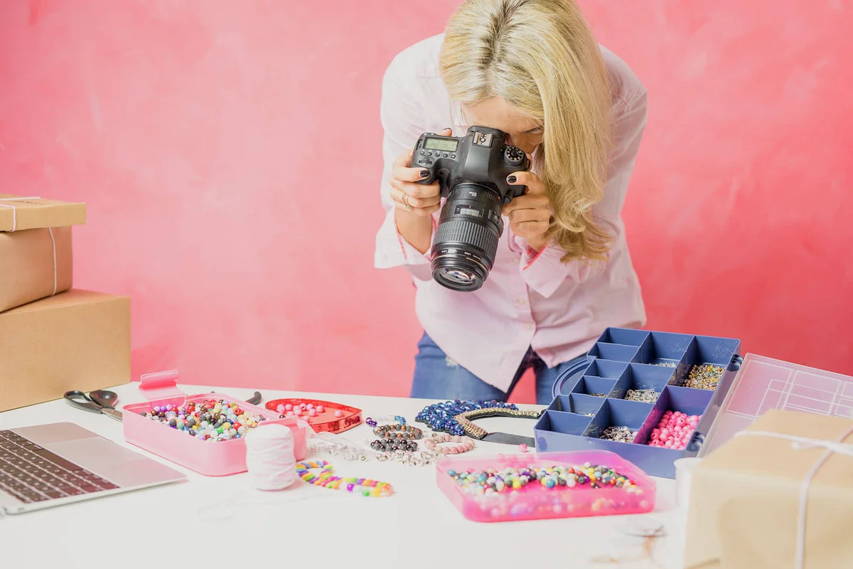 Woman taking photos of her own created merchandise