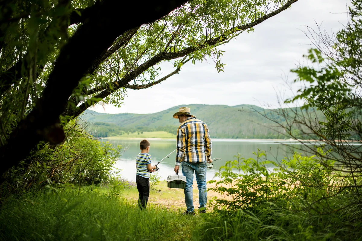 A little boy and his grandfather go fishing