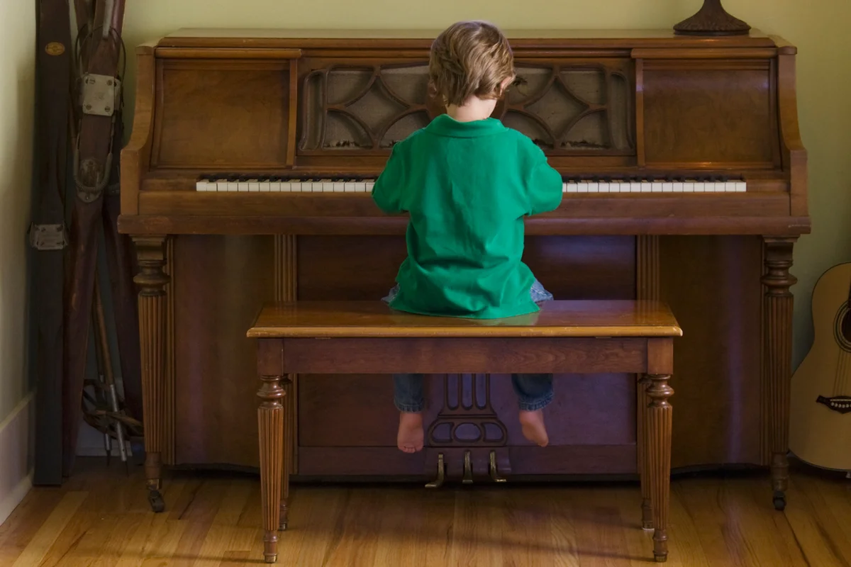 boy playing piano at home