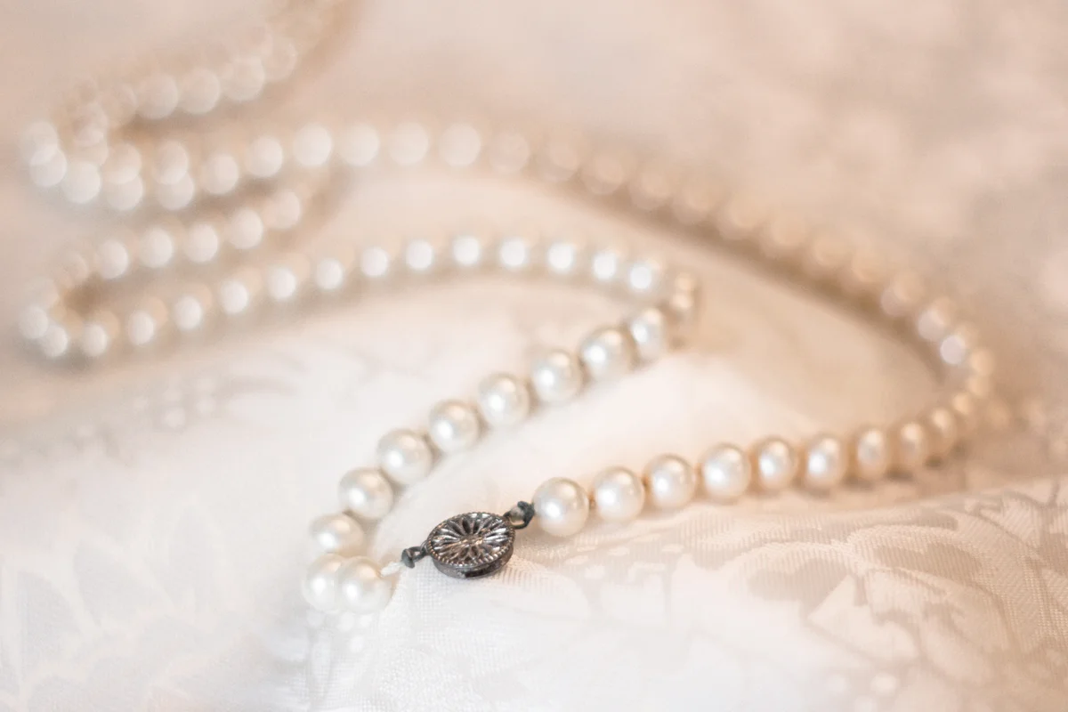 Vintage pearl necklace on floral satin fabric