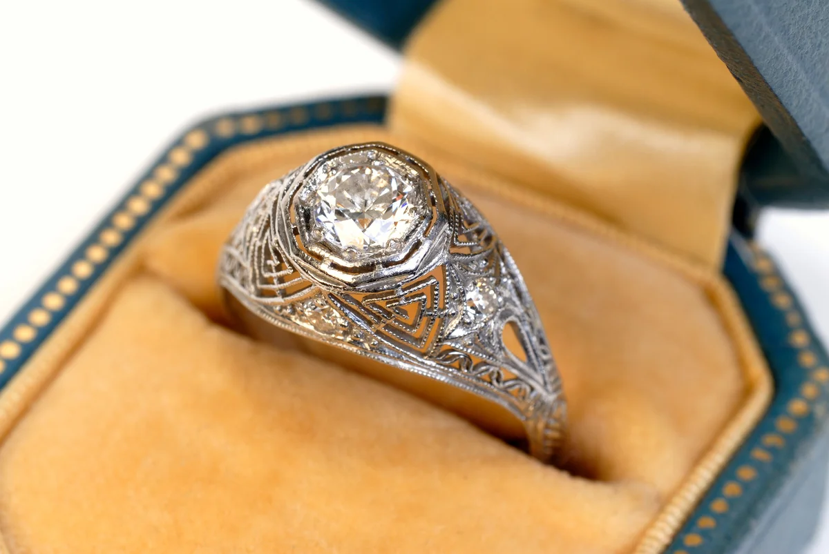 antique diamond ring with the diamond set in a platinum basket setting
